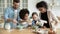 Full multi ethnic family cooking pancakes together in modern kitchen