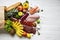 Full paper bag of healthy raw food on white wooden table. Cooking food background. Flat-lay of fresh fruits, veggies, greens, diff