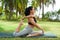 full pigeon pose (mermaid pose) or eka pada rajakapotasana yoga with ukrainian woman making it outdoors