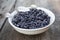 Full plate of Blueberries on wooden table