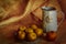 A full plate of ripe apples collected in his garden. Jug with homemade drink. Harvest season in the village. Semi-matt background.