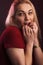 Full plus size high fashion xxl woman posing in Studio, In a red dress on a maroon background