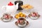 Full porcelain teacups with hot tea and with floral pattern, biscuits and plate with wild apricots