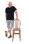Full portrait of a  bald man with shorts playing with a chair on white background
