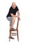 Full portrait of a  bald man with shorts playing with a chair on white background, foot on the chair