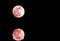 Full red moon and lunar reflection on the surface of the wate
