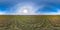 Full seamless spherical hdri panorama 360 degrees angle view among fields in early spring day with sun on clear sky with halo in