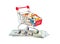 Full shopping cart with pills on dollar bills on white background