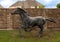 Full size bronze sculpture of a horse running beside a neighborhood in the Phillips Creek Ranch development in Frisco, Texas