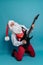 Full size of emotional Santa Claus who plays on electric guitar on blue background. Christmas party.