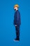 Full size fullbody snap with legs, profile portrait of calm handsome repairer in blue uniform, isolated on grey