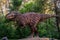 Full-size gigantosaurus statue in the forest of Belgorod dinopark. Carnivorous toothy predator.