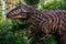 Full-size gigantosaurus statue in the forest of Belgorod dinopark. Carnivorous toothy predator