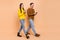 Full size hoto of brunette busy couple go look telephones wear sweaters jeans shoes isolated on beige background