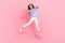 Full size photo of active carefree person jumping show thumbs up isolated on pink color background