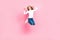 Full size photo of active excited girl jumping point thumb fingers herself isolated on pink color background