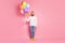 Full size photo candid imposing guy hold many air balloons wait birthday party celebration look copyspace feel curious