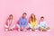 Full size photo of charming family daddy mommy small boy girl sit floor legs crossed isolated on pastel color background