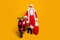 Full size photo of confident grandfather in red santa claus hat true driver rider hold big sack x-mas dream gift stand