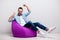 Full size photo of crazy guy watch tv sitting comfortable soft violet armchair celebrate football match team goal wear