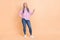 Full size photo of cute white hairdo lady index empty space wear violet garment jeans shoes isolated on beige background