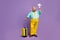 Full size photo excited man big abdomen hold papercard plane travel abroad weekend touch yellow suitcase wear shine