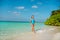 Full size photo of fit pretty girl go walk azure ocean bay water coast white sand enjoy exotic resort relax under blue