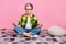 Full size photo of focused person with short hairstyle dressed plaid shirt sitting on floor meditating isolated on pink