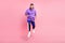 Full size photo of funky millennial brunet guy run wear hoodie pants shoes isolated on pink background