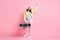 Full size photo of funky sweet girl dance hold boombox wear cap jacket trousers sneakers isolated on pastel pink color