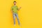 Full size photo of good beard young guy index promo wear t-shirt jeans footwear isolated on yellow color background
