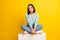 Full size photo of gorgeous pleasant kind woman dressed blue pullover sit on cube toothy smiling isolated on yellow