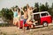 Full size photo of group overjoyed buddies hold hands jumping enjoy free time rejoice sand beach outdoors