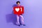 Full size photo of handsome pleasant person dressed violet hoodie hold big red social media like isolated on purple