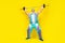 Full size photo of handsome sportive granddad hold raise barbell up isolated on yellow color background