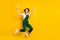 Full size photo of happy cheerful crazy girl painter hold roller jumping in excitement isolated on yellow color