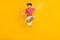 Full size photo of happy cheerful young raise fists jump up good mood winner isolated on yellow color background