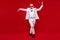 Full size photo of happy positive old man dance christmas event entertainer isolated on red color background