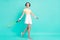 Full size photo of happy smiling good mood girl go walk training playing tennis badminton isolated on teal color