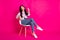 Full size photo of impressed brunette nice lady sit look empty space wear jacket jeans sneakers isolated on pink