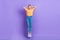 Full size photo of impressed staring girl wear yellow t-shirt denim trousers hold arms on head isolated on purple color