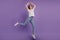 Full size photo of joyful carefree girl jump air fly hands up elegant ballerina isolated on violet color background
