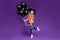 Full size photo of little witch lady halloween party holding many air balloons excited chilling wear orange t-shirt