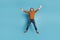 Full size photo of mature happy crazy smiling man jumping in star pose screaming in excitement isolated on blue color