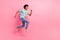 Full size photo of nice young guy running fast shopping sales dressed stylish blue outfit isolated on pink color