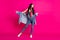 Full size photo of optimistic brunette nice lady stand look wear top jacket jeans sneakers isolated on pink color