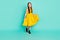 Full size photo of optimistic nice brown hair girl wear yellow dress shoes isolated on bright teal color background