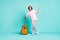 Full size photo of optimistic stylish guitarist standing wear cool outfit isolated on teal color background