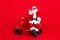Full size photo of pleasant grandfather wear stylish santa costume sit on moped indicating empty space isolated on red