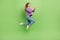 Full size photo of positive cheerful girl dressed jeans purple pullover hold smartphone typing sms isolated on green